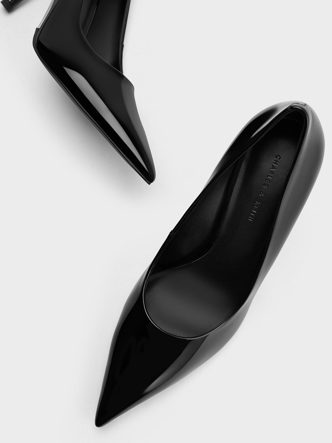 Kaia pointed barely there sales heel in black patent