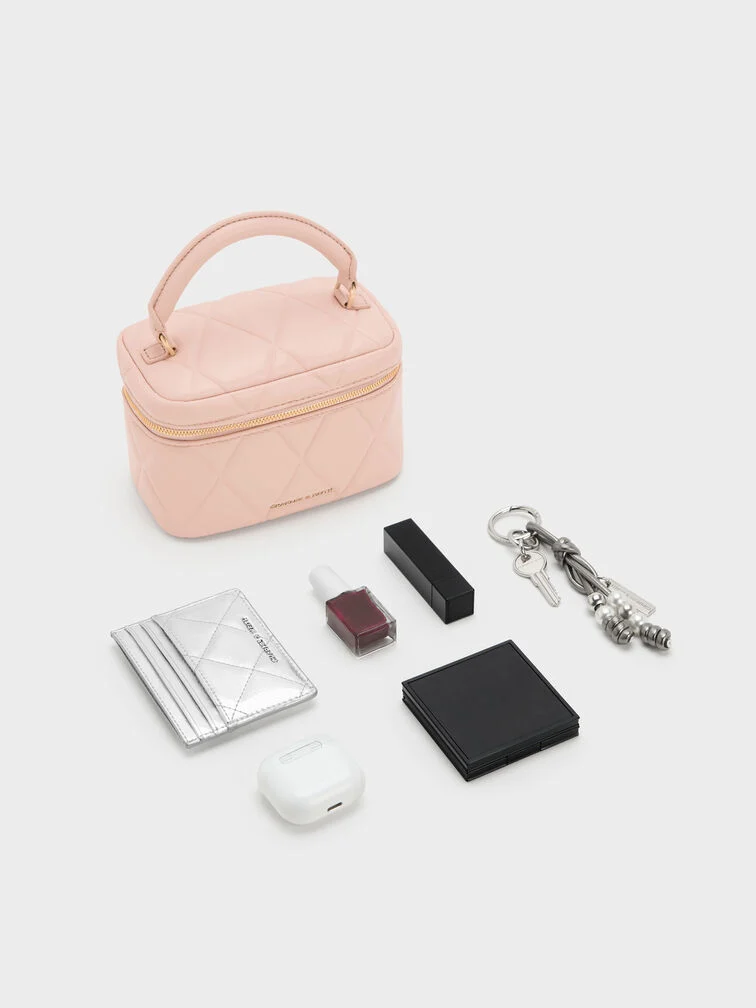 Pink quilted vanity bag with top handle, the perfect choice for a girls’ night out.