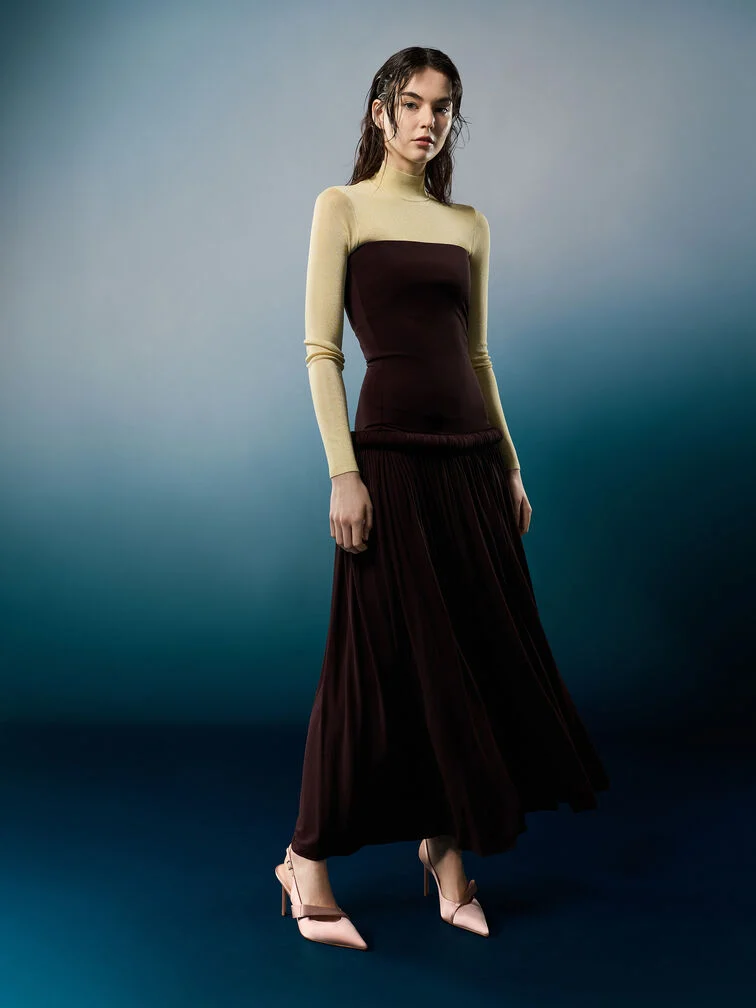 A statement velvet dress styled with sleek pointed-toe pumps creates an elegant late-fall wedding guest look.