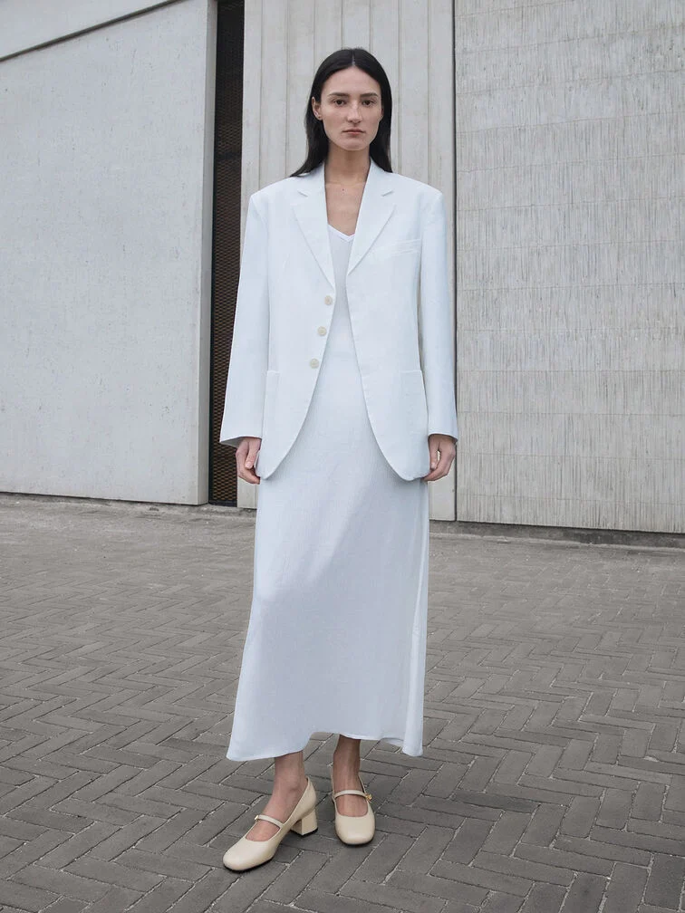 Chalk block-heel Mary Janes paired with a white dress-and-blazer outfit for a monochrome ensemble