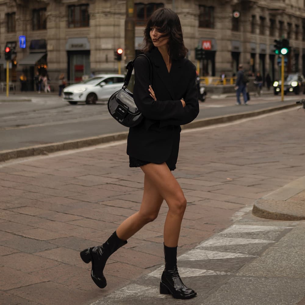 The Lula patent handbag and boots spotted on the streets of New York City and Milan during Fashion Week.