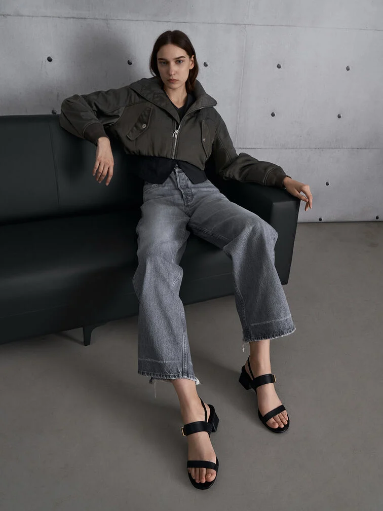 Frayed wide-leg jeans pair perfectly with black block-heel sandals for a casual and laid-back look.