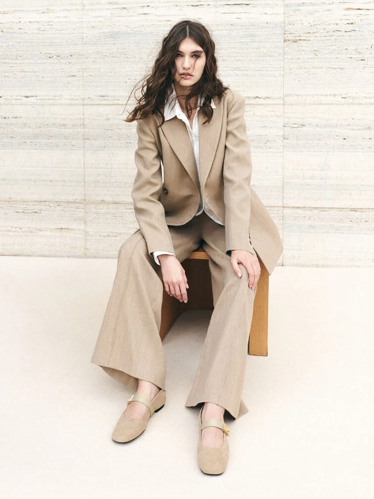 Beige Mary Jane flats paired with a matching pantsuit for a clean, timeless look.