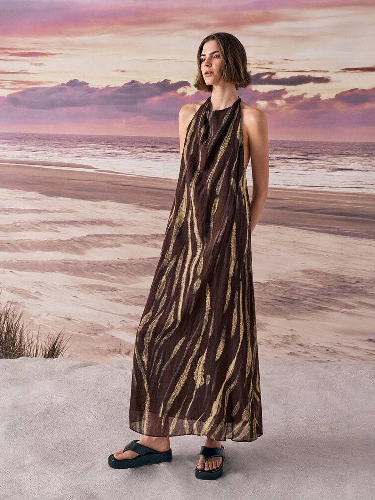Printed maxi dress paired with black thong sandals for a summer-ready outfit