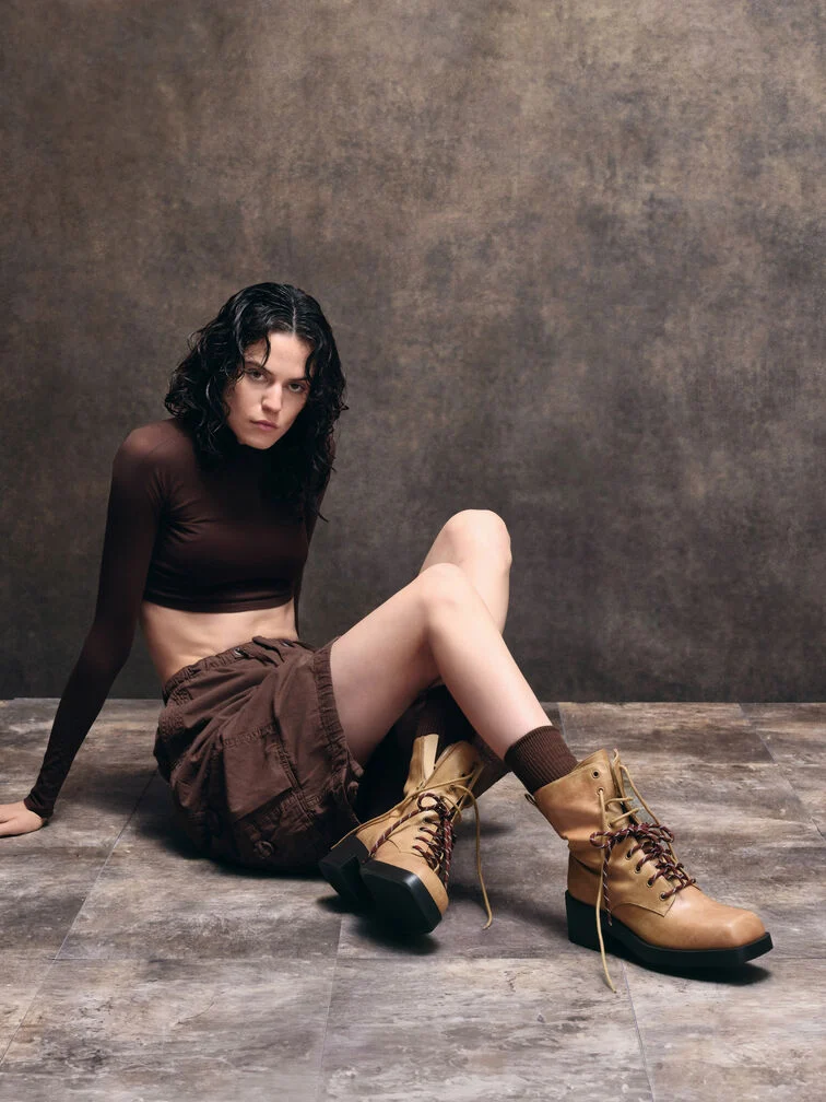 Styling brown boots with a coordinated tonal brown outfit.