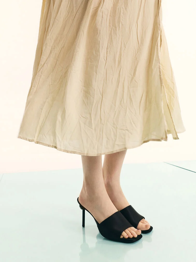 Yellow linen dress styled with black heeled mules. 