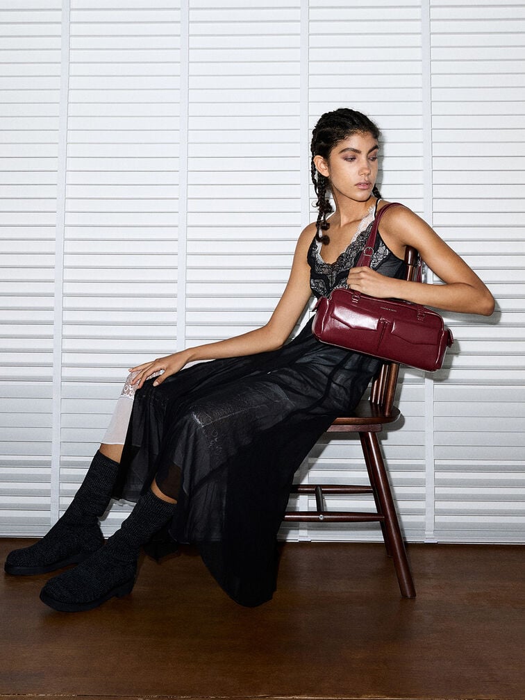 Burgundy Rachel East-West bag with front pockets and elongated top handles. 