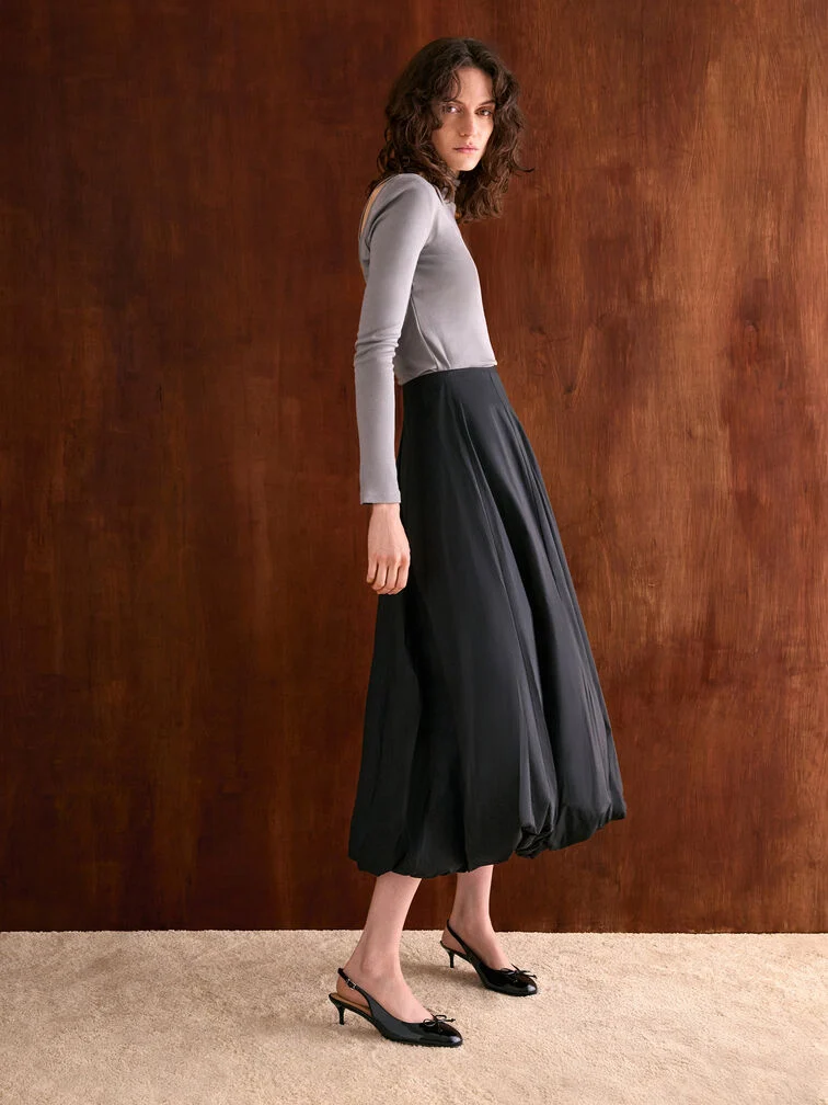 Black leather slingback kitten heels paired with a bubble skirt and fitted grey top - CHARLES & KEITH