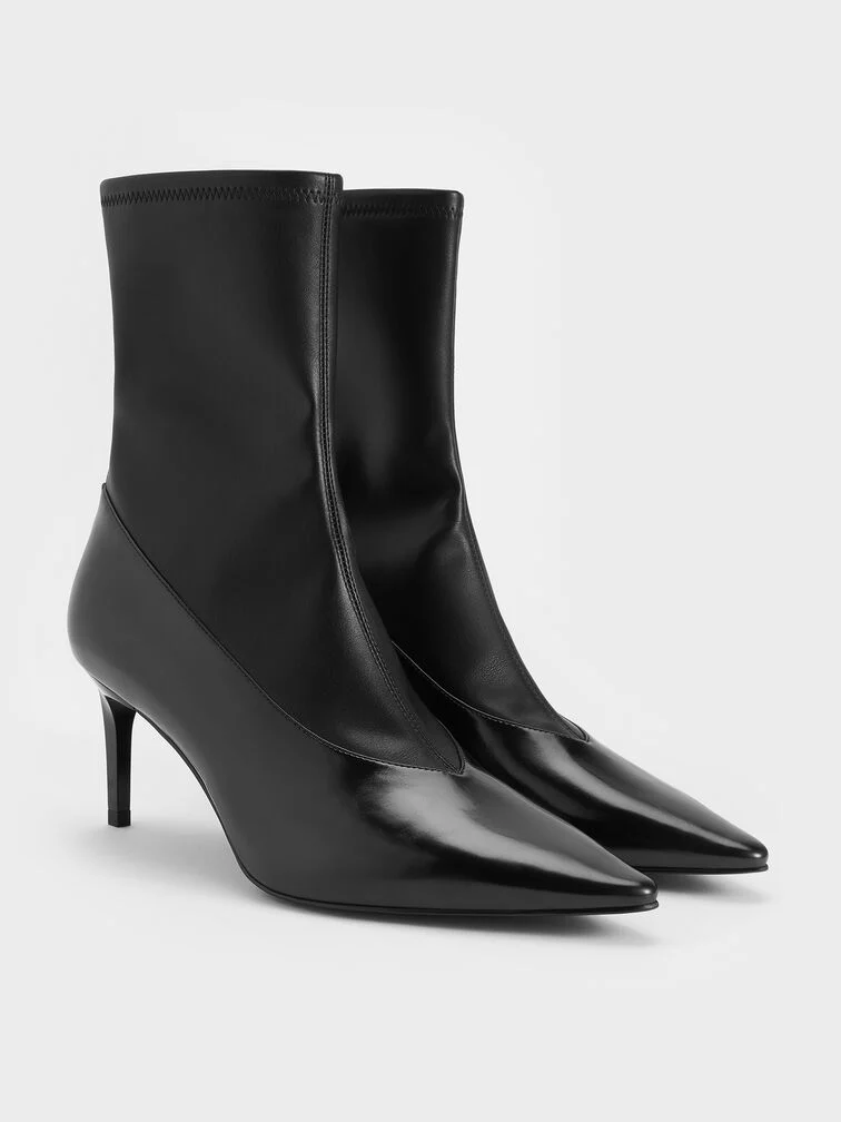  Black stiletto ankle boots, a chic footwear choice for fall weddings at indoor venues.