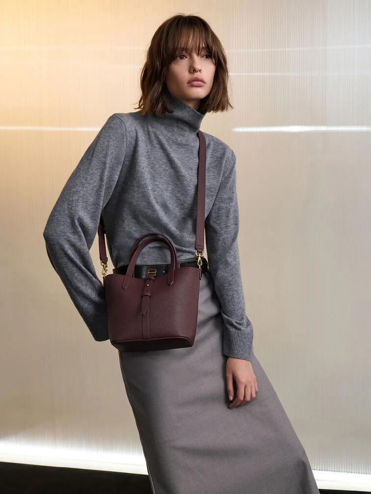 A grey turtleneck top styled with a maxi skirt for an outfit that is appropriate for presentations.