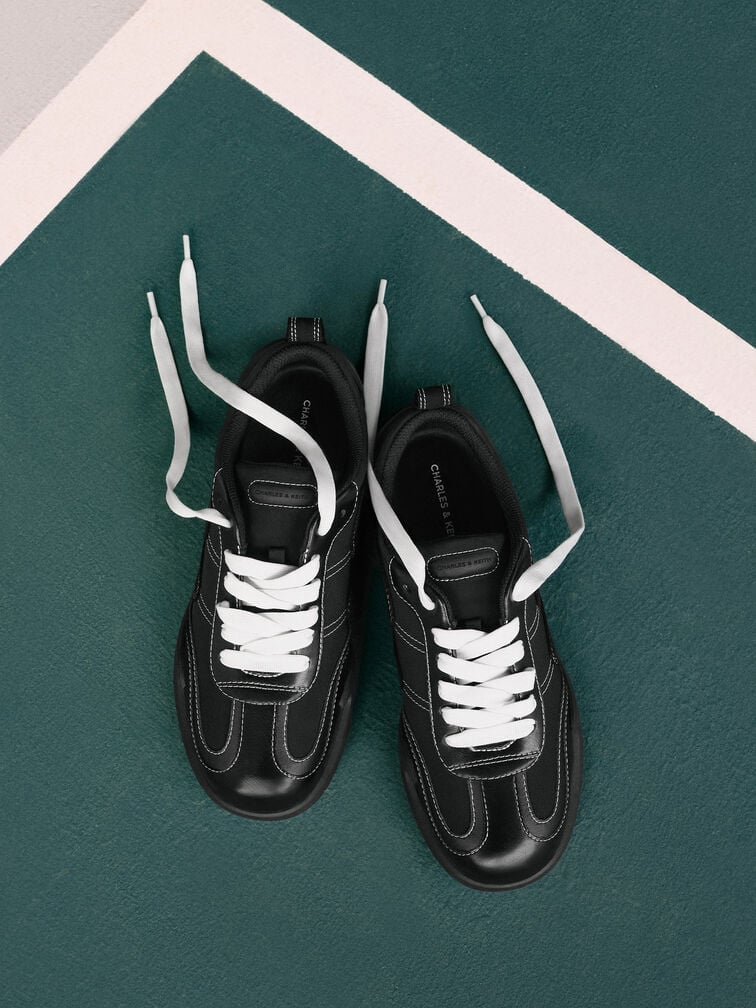 Trendy, black low-profile sneakers will effortlessly complement your denim-on-denim outfit.  