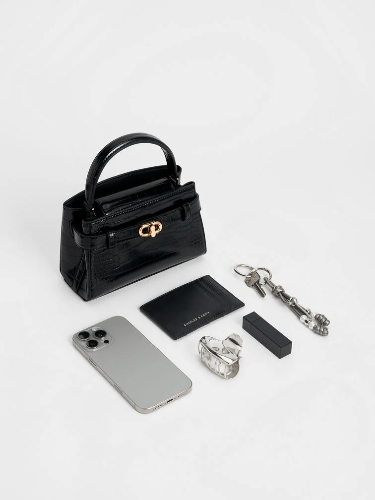 A croc-effect top handle bag will add a statement-making element to your wedding guest ensemble.