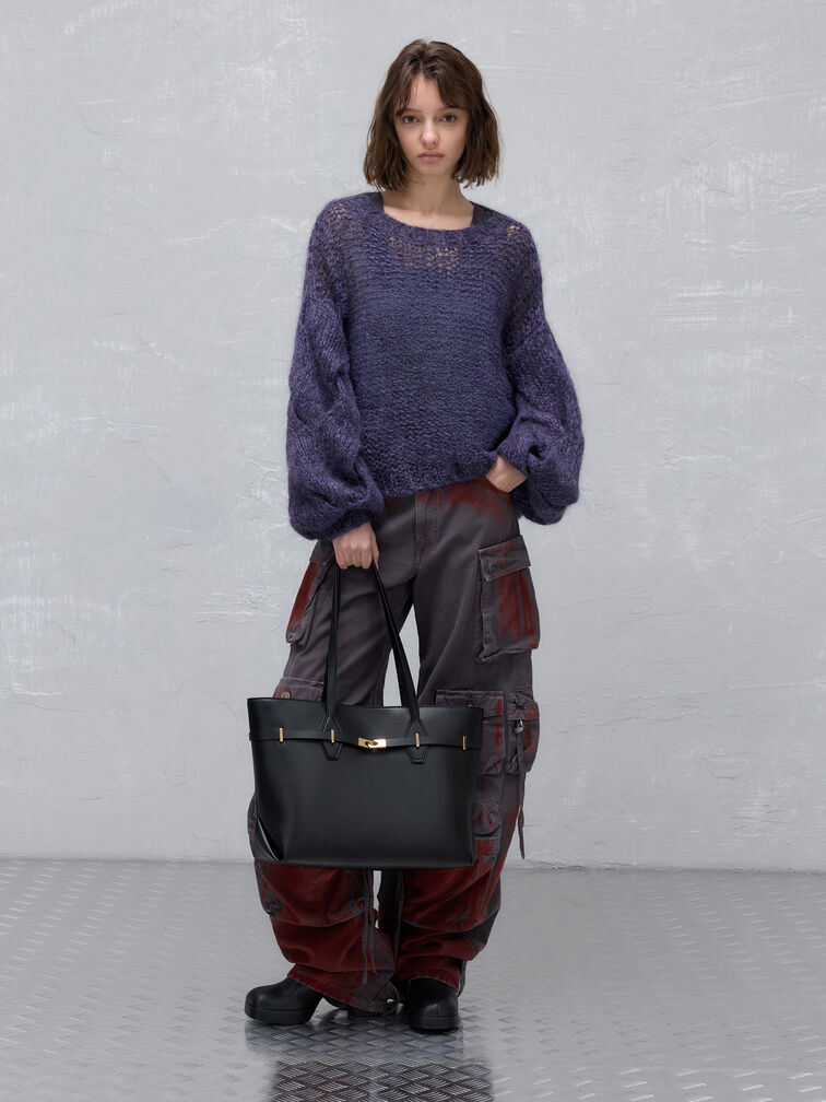 Knitted sweater paired with distressed cargo trousers and a spacious tote bag for carrying campus essentials.