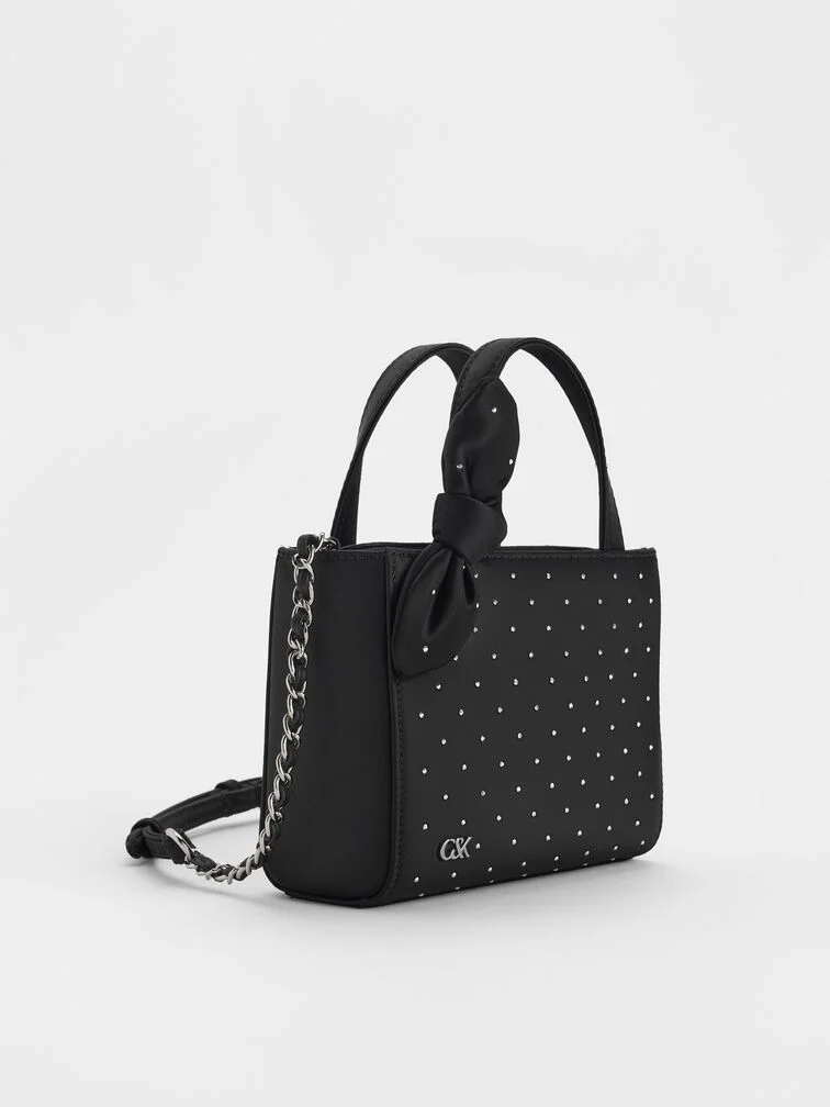 Noir satin studded mini bag, an elevated finishing touch. 