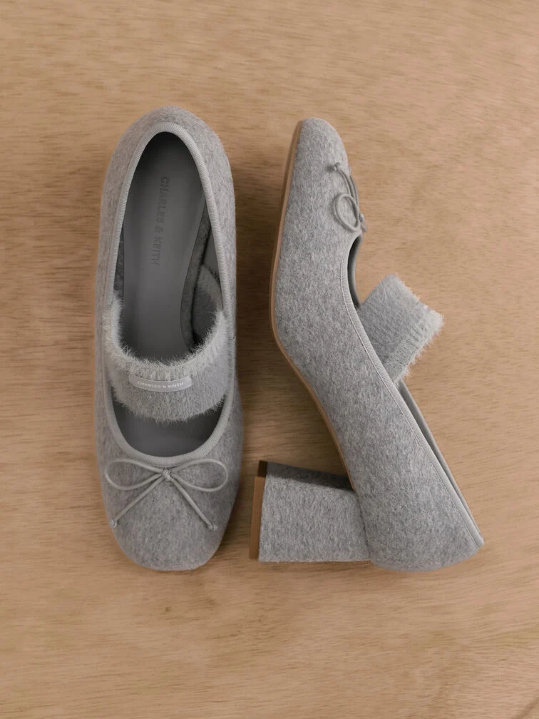 With an eye-catching fuzzy texture, these felt Mary Jane pumps in versatile grey are a fun and stylish update of the classic shoe style. 